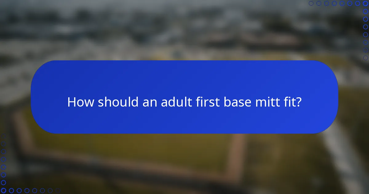 How should an adult first base mitt fit?
